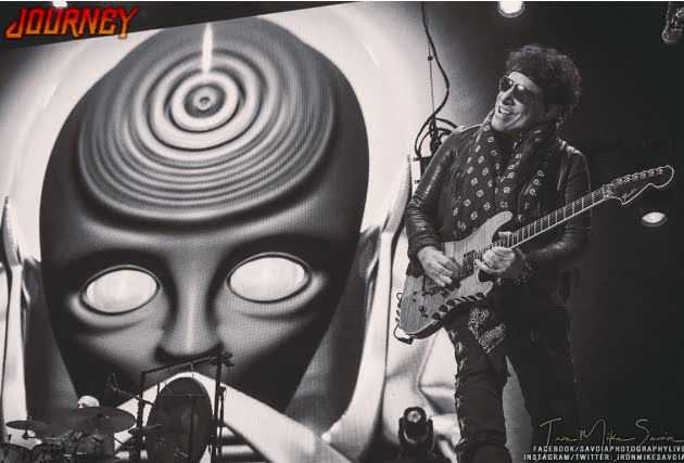 Neal Schon Playing guitar in front of robotic head Journey and Def Leppard tour 2018