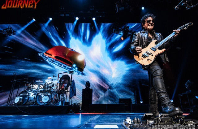 Neal Schon Guitar Legend plays Guitar with a vivid backdrop Variety of Images