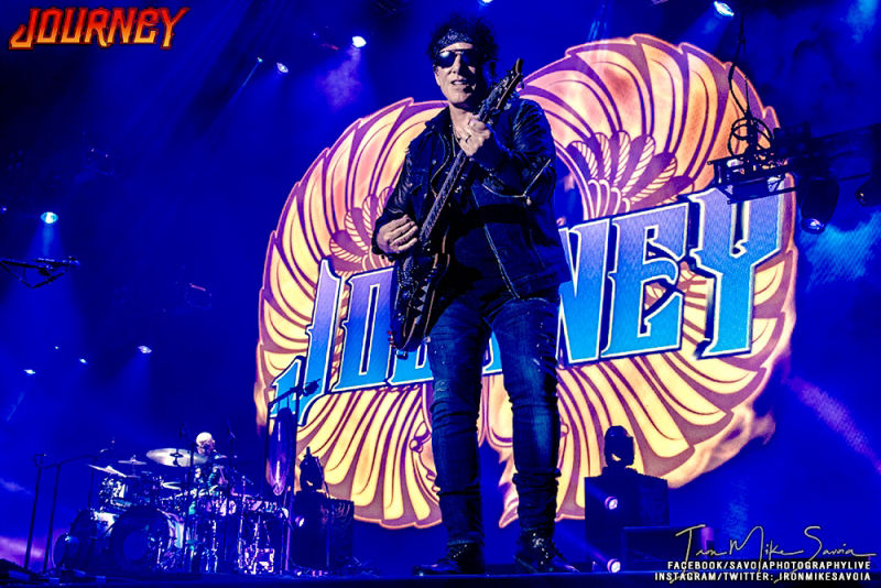 Neal Schon Plays guitar in front of colorful Journey backdrop on Tour with Def Leppard 2018